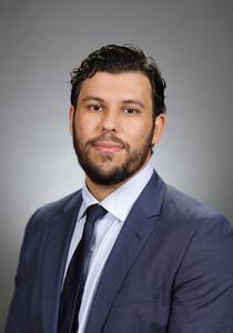 An Arab-American man in a suit and tie